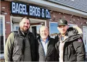  ?? Ned Gerard / Hearst Connecticu­t Media ?? Owners Remzi Nasufi, center, stands with his sons Ali, left, and Flamur in front of the future location of Bagel Bros & Co., in Shelton on Thursday.