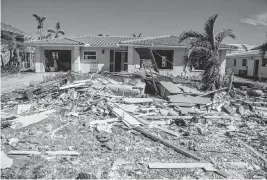  ?? PEDRO PORTAL TNS ?? Debris from Hurricane Ian remains in the front yard of a Fort Myers Beach home Oct. 26, 2022, a month after the Category 4 storm hit the area.