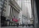  ?? MARY ALTAFFER — THE ASSOCIATED PRESS ?? Pedestrian­s walk past the New York Stock Exchange, Tuesday. Stocks dropped again Tuesday as losses mounted for the world’s largest technology companies.