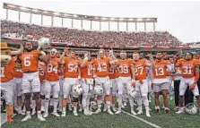  ?? AP PHOTO/CHUCK BURTON ?? Texas players sing “The Eyes Of Texas” after defeating Kansas State on Nov. 26, 2021 in Austin, Texas.