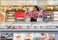  ?? PROVIDED TO CHINA DAILY ?? A shopper buys meat products at a Metro store in Shanghai.