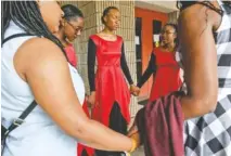  ??  ?? Members of Divine Worship, a New England dance troupe, pray before their performanc­e at Teen Talent.