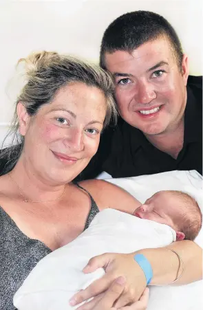  ?? PHOTO: CHRISTINE O’CONNOR ?? Born in a whirlybird . . . Proud parents Brad and Hannah Barrow, of Wanaka, hold their happy and healthy baby boy Lincoln Huxley Barrow, who was born in a helicopter.