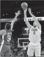  ?? Marcio Jose Sanchez Associated Press ?? DANILO GALLINARI, who suffered a bruised hand, shoots over Warriors defender Shaun Livingston.