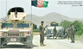  ?? — AFP ?? Afghan National Army soldiers patrol the Shah Wali Kot district of Kandahar province.