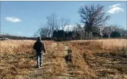  ?? TIA MITCHELL / TIA.MITCHELL@AJC.COM ?? Joe Peery walks on a parcel of land owned by Blackhall movie studio that is part of a proposed land swap with DeKalb County that would allow the company to build on a portion of Intrenchme­nt Creek Park.