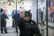  ?? KEREM YÜCEL/MINNESOTA PUBLIC RADIO VIA AP ?? A Bloomingto­n Police officer holds up their hand at the entrance to the Mall of America in Bloomingto­n, Minn., after reports of shots fired on Friday, Dec. 23, 2022.