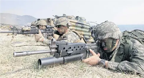  ?? AP ?? South Korean and US marines aim weapons during the 2015 joint military excercise ‘Foal Eagle’ between the two countries in Pohang, South Korea.