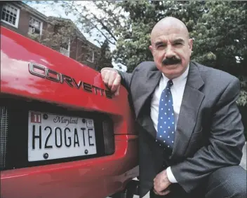  ?? RON EDMONDS ?? IN THIS, JUNE 9, 1997, FILE PHOTO, G. Gordon Liddy kneels next to his Corvette outside the Fairfax, Va., radio station where he broadcasts his syndicated radio talk show.
