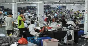 ?? ?? Workers make clothes at a garment factory that supplies shein, a cross-border fast fashion e-commerce company in China.