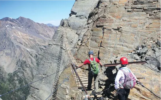  ?? ANDREW PENNER ?? The death-defying suspension bridge on the Mount Nimbus via ferrata will test the nerve of climbers, even though they are securely attached to fixed cables.