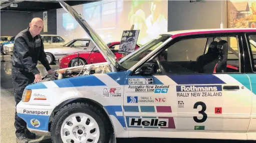  ?? PHOTO: LUISA GIRAO ?? Under the bonnet . . . Transport World workshop team member Darren Robbie inspects a Mazda 323 4WD, one of the highlights of The Evolution of Japanese Cars exhibit.