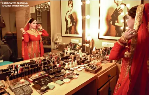  ??  ?? A BRIDE GIVES FINISHING TOUCHES TO HER MAKEUP
RONICKA KANDHARI