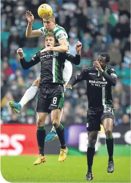  ??  ?? Jozo Simunovic gets above Hibernian’s Vykintas Slivka to clear the danger at Celtic Park yesterday