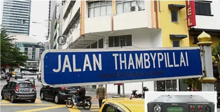  ?? — Reuters ?? Cloak and dagger: A general view of the building housing Glocom’s offices in Brickfield­s, Kuala Lumpur. (Inset) A Glocom GR-150 high frequency radio featured on the company’s equipment catalogue.