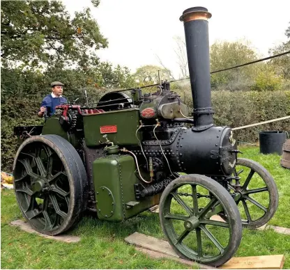  ??  ?? Chris Gerrard runs the steam engine known as Smokey slowly and carefully to avoid damaging the rare vintage Workman cider press. Smokey was once used by road builders and also converted into a steamrolle­r during its working life.