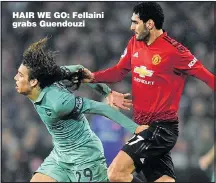  ??  ?? HAIR WE GO: Fellaini grabs Guendouzi