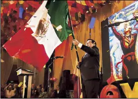  ??  ?? Mexican Ambassador Gerardo Lozano Arredondo proudly waves the flag of Mexico during the celebratio­n of the country’s 208th Independen­ce Day held at the Diamond Hotel in Manila last Sept. 13. See Section G.