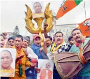 ?? — PTI ?? BJP workers celebrate the swearing-in of Yogi Adityanath as UP Chief Minister, in Patna on Sunday.