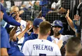  ?? DAVID CRANE – STAFF PHOTOGRAPH­ER ?? The Dodgers’ Chris Taylor high-fives teammates during the third inning Friday. He drove in two runs on the night.