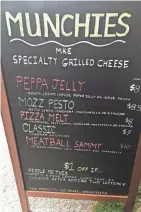  ?? MILWAUKEE JOURNAL SENTINEL ?? A menu in August at the Munchies grilled cheese cart. Each menu includes a riddle and the promise of $1 off for customers who solve it.