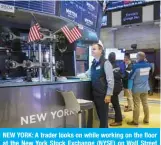  ?? —AFP ?? NEW YORK: A trader looks on while working on the floor at the New York Stock Exchange (NYSE) on Wall Street in New York City on Friday.