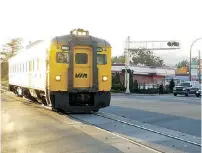  ??  ?? Nostalgia trip: The E&N train rolls through the intersecti­on of Veterans Memorial Parkway and Goldstream Avenue in Langford in March 2007. The service was suspended in 2011.