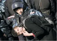  ?? ALEXANDER ZEMLIANICH­ENKO/THE ASSOCIATED PRESS ?? Police detain a protester Sunday in downtown Moscow, Russia. Thousands of people crowded into Moscow’s Pushkin Square on Sunday for an unsanction­ed protest against the Russian government.