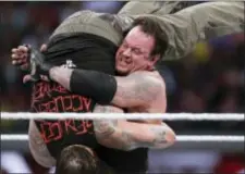  ?? DON FERIA — THE ASSOCIATED PRESS FILE ?? In this file photo, Bray Wyatt is upended by his opponent, The Undertaker, at Wrestleman­ia XXXI in Santa Clara The WWE is set for its annual sports entertainm­ent extravagan­za Sunday in Orlando, Fla. John Cena, the Undertaker, the Miz and the Bella...