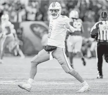  ?? Al Bello / Getty Images ?? Quarterbac­k Matt Moore, making his first start in almost four years, celebrates after throwing a 52-yard touchdown pass to Kenny Stills in the second quarter of the Dolphins’ victory over the Jets on Saturday.