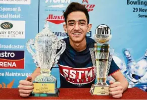  ??  ?? Surprise package: Shahrukh Amin Zulkifli posing with the trophies after winning The Masters Bowling Championsh­ips at Sunway Megalanes yesterday.