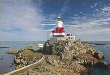  ??  ?? Our beacons of hope and emblems of the blustery coast are celebrated in a new book by Nicholas Leach and Tony Denton, Lighthouse­s of England and Wales (£40, The History Press), which includes this photograph of the lighthouse on the Skerries, off Anglesey