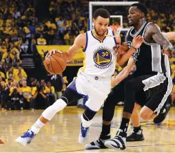  ?? (Reuters) ?? GOLDEN STATE WARRIORS guard Steph Curry (left) dribbles past San Antonio Spurs defender Dewayne Dedmon during the first quarter of the Warriors’ 136-130 home triumph on Tuesday night. Curry racked up 29 points, seven rebounds and seven assists in three...