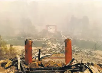  ?? Kurtis Alexander / The Chronicle ?? Above: The Honey Run Covered Bridge, between Butte Creek Canyon and Paradise Ridge, was consumed by the Camp Fire.