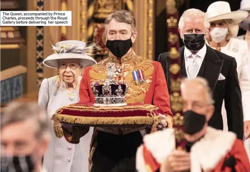  ??  ?? The Queen, accompanie­d by Prince Charles, proceeds through the Royal Gallery before delivering her speech