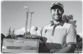  ??  ?? Adam Hadwin with the unusual trophy he won in Chile.