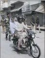  ??  ?? ON PATROL: An Indian Muslim couple ride past a group of paramilita­ry soldiers.