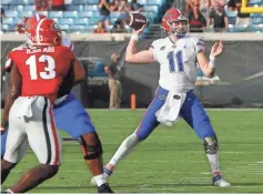  ?? BRAD MCCLENNY/ THE GAINESVILL­E (FLA.) SUN ?? Kyle Trask threw for 474 yards and four TDs in Florida’s win over Georgia.