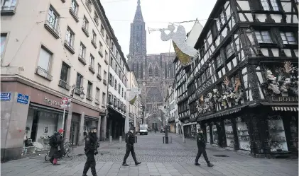  ?? Picture: AFP ?? AT THE READY. French gendarmes yesterday patrol in front of the Strasbourg cathedral while searches are conducted for the gunman who opened fire near a Christmas market in Strasbourg the night before.