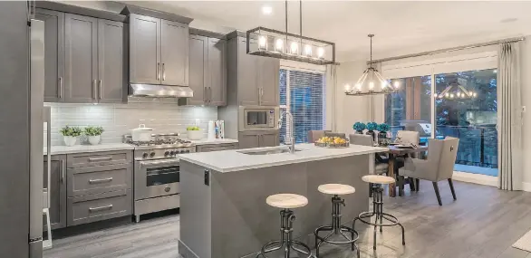  ??  ?? Kitchens at Portrait Homes’ Viridian townhome developmen­t in South Surrey feature LED pot lighting throughout and contempora­ry Shaker-style cabinetry with soft-close hardware.