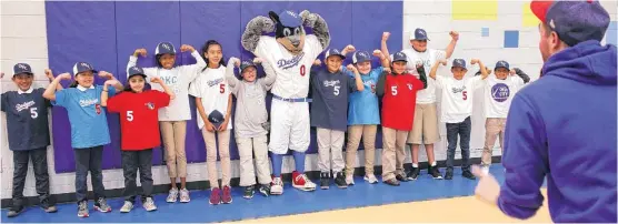  ?? [PHOTOS BY DOUG HOKE, THE OKLAHOMAN] ?? Students at Eugene Fields Elementary School model baseball jerseys while posing with OKC Dodgers mascot Brix on Wednesday.