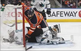  ?? JASON FRANSON – THE CANADIAN PRESS VIA AP ?? Sharks goaltender Aaron Dell, right, shown getting run into by the Oilers’ Zack Kassian, stopped 18of 19shots in the final two periods in San Jose’s 6-3victory Thursday night.