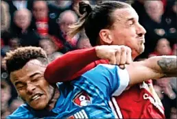  ??  ?? HITTING BACK: Zlatan (right) elbows Mings after his stamp on the Swede