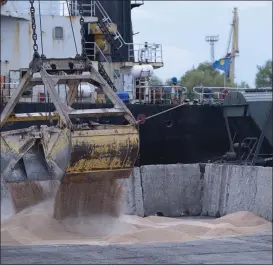  ?? ANDREW KRAVCHENKO - THE ASSOCIATED PRESS ?? Workers load grain at a port in Izmail, Ukraine, on April 26. A deal that has allowed for shipments of Ukrainian grain through the Black Sea to parts of the world struggling with hunger has been extended.