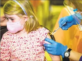  ?? Alisha Jucevic For The Times ?? REBECCA KELLEN, 7, gets vaccinated on May 21 in Encino. Los Angeles County on Friday reported its 12th COVID-19 death in a person younger than 18.