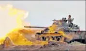  ?? AP ?? A frame grab from video provided by progovernm­ent Syrian Central Military Media shows a tank firing on militant positions.