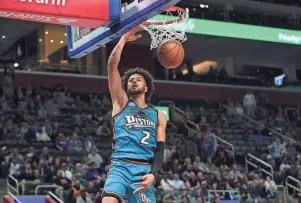  ?? PAUL SANCYA/AP ?? Cade Cunningham dunks against the Hawks in the first half at Little Caesars Arena on Friday night.