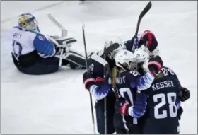  ?? JULIO CORTEZ — THE ASSOCIATED PRESS ?? Members of the United States women’s ice hockey team celebrate after Dani Cameranesi (24) scores a goal against Finland during the third period of the semifinal round at the 2018 Winter Olympics in Gangneung, South Korea.