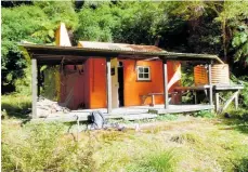  ?? Photo / Pete Shaw ?? One of the Department of Conservati­on back country huts in Te Urewera given historic status within the department, Waiotukapi­ti Hut.