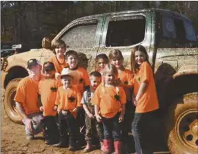  ??  ?? Group of youngsters pose for picture following a trip to a local mud bog.